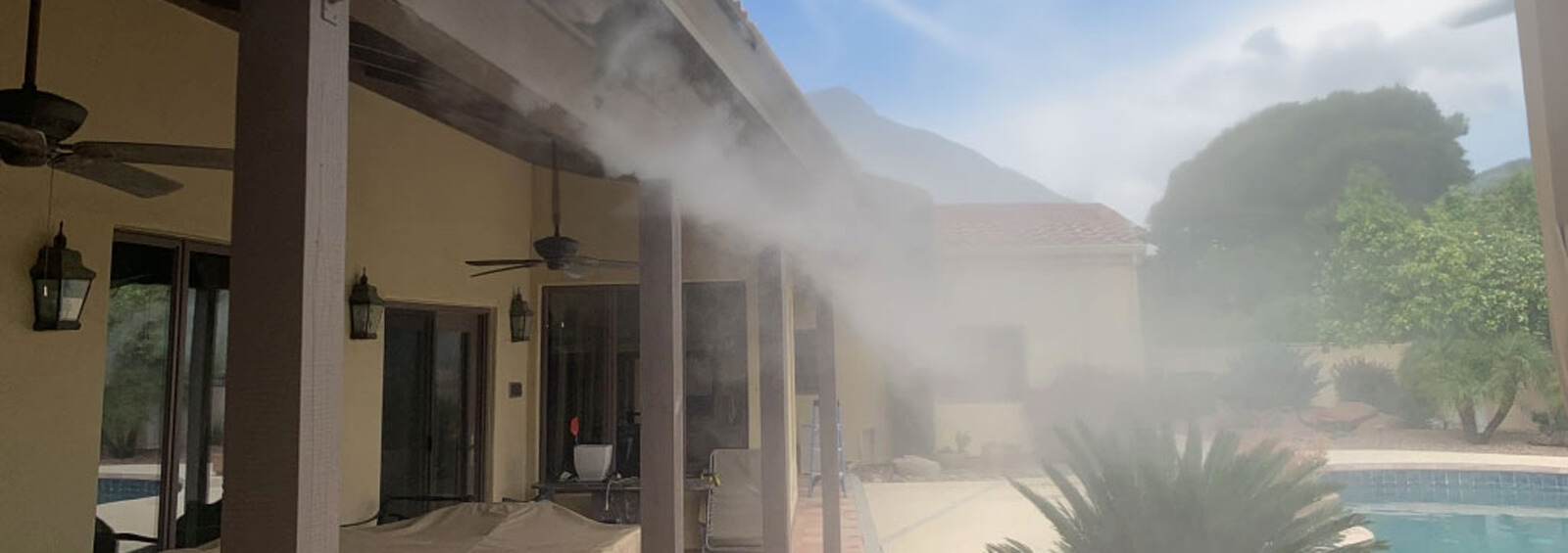 Misters installed on a the overhang of a backyard pool