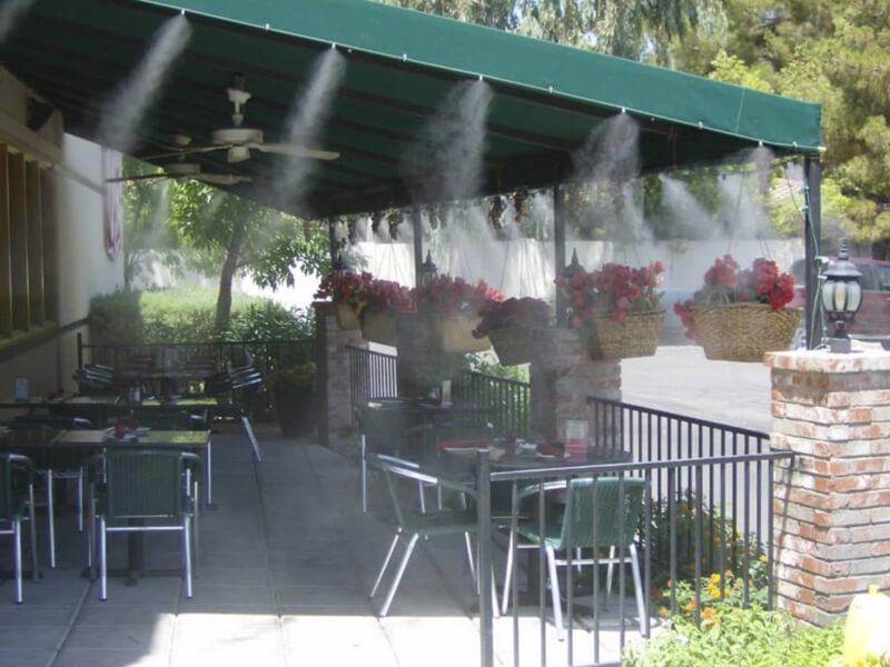 Misters installed on a canvas overhang of an outdoor restaurant