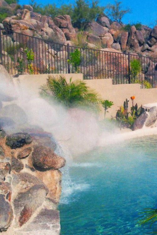 Misters being displayed on a waterfall of a backyard pool in Mesa, AZ