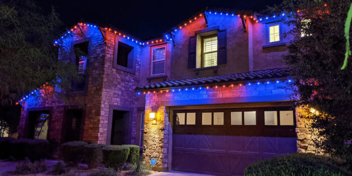Holiday lights installed on an exterior of a home