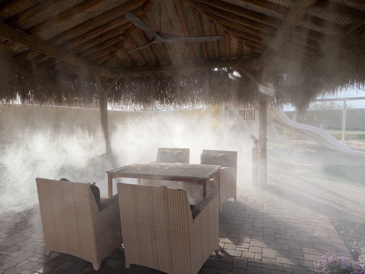 Patio Seating Misting System Misting system operating above a patio dining table and chairs